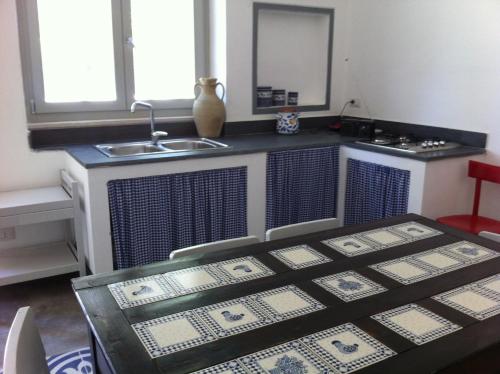 a kitchen with a sink and a table with a sink at Masseria Montedoro in Ginosa Marina