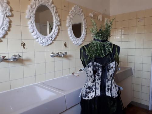 a bathroom with a robe with flowers on a tub at Haus im grünen - Hürth in Fischenich