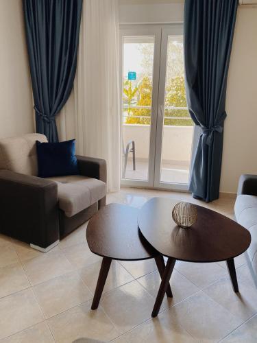a living room with a couch and a table at Sun Village Aparthotel in Herceg-Novi