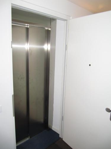 a closet with a glass door in a room at Relax Suite in Merano