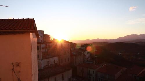 a view of the sun setting over a city at Casa di Emilia in Carpinone