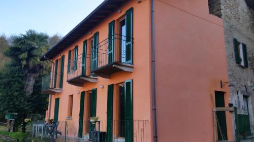 an orange building with balconies on the side of it at B&B Val Valerna in Lezzeno