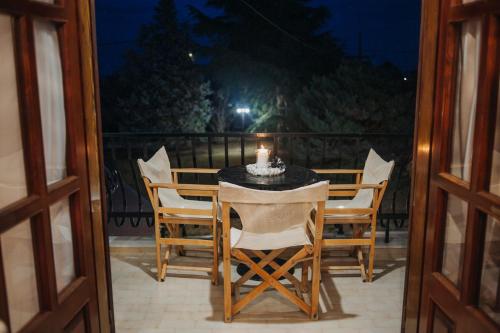 a candle sitting on top of a table on a balcony at Mythic House in Leptokaria