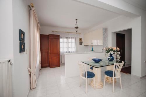 a kitchen with a table and chairs and a kitchen with a counter at Mythic House in Leptokaria