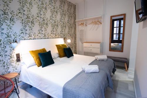 a bedroom with two beds in a room at Granadi Apartamentos in Granada