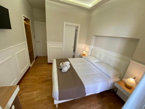 a bedroom with a large white bed in a room at MAMO al Museo in Naples