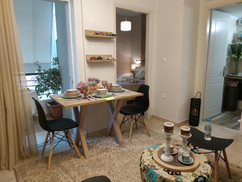 a living room with a table with chairs and a dining room at Boheme and Style in Preveza
