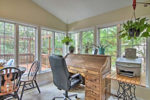 a home office with a desk and chairs and windows at 2 Mi to Golf Retreat with Hot Tub in Ocean Pines in Ocean Pines