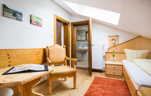 a small room with a desk and a bed and a bedroom at Gästehaus Fitsch in Obsteig