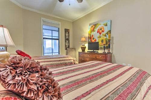 a bedroom with two beds and a tv in it at Ornate Resort Condo with Balcony, Pool, Water Views! in Pensacola