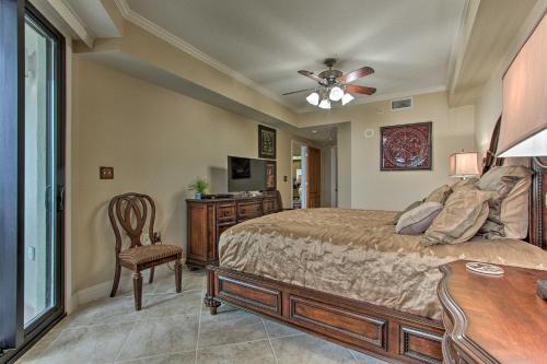 a bedroom with a bed and a table and a chair at Ornate Resort Condo with Balcony, Pool, Water Views! in Pensacola