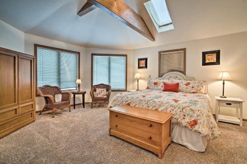 a bedroom with a bed with a dresser and a tv at Modern Retreat with Hot Tub - Steps to Lake Chelan! in Manson