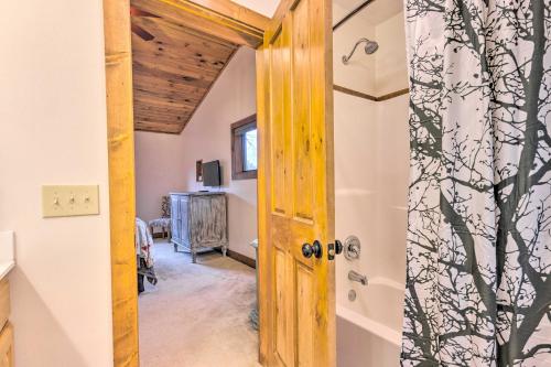 a door leading into a room with a bathroom at Mountain Cabin with Fire Pit, Walk to Golf and Fishing in Vilas