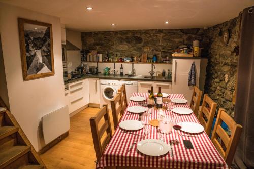 una cucina con tavolo e tovaglia rossa e bianca di Prachtig familie appartement voor 6 personen in het hart van Argentière, Chamonix Mont-Blanc a Chamonix-Mont-Blanc