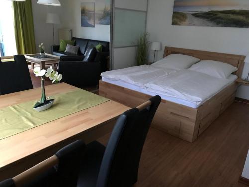 a bedroom with a bed and a table and a couch at Steiner Strandappartements Appartement 201 Seeseite in Stein