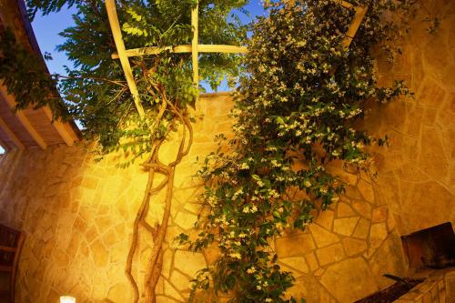 a group of trees on a wall with a cross at Bed and Breakfast BLUE in BLUE in Komiža