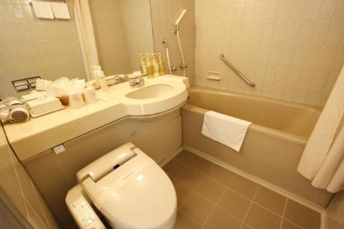 a bathroom with a toilet and a sink and a tub at Hotel Abest Meguro / Vacation STAY 71406 in Tokyo
