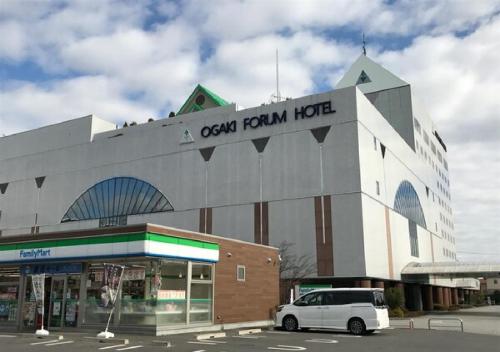 a white car parked in front of a building at Ogaki Forum Hotel / Vacation STAY 72181 in Ogaki