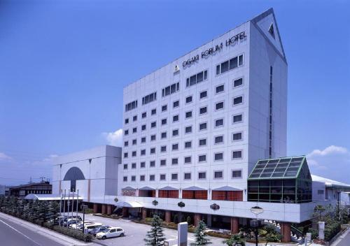 a white building with a car parked in front of it at Ogaki Forum Hotel / Vacation STAY 72183 in Ogaki
