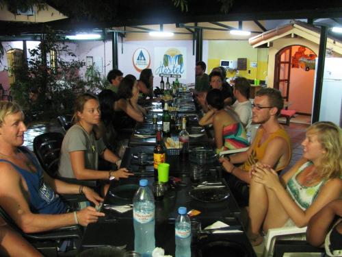 a group of people sitting around a long table at Hostel Iguazu Falls in Puerto Iguazú