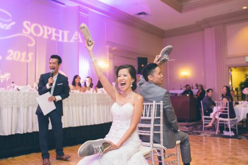 a bride and groom holding their shoes up in the air at Crowne Plaza Hotel Portland-Downtown Convention Center by IHG in Portland