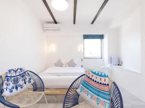 a room with two wicker chairs and a bed at Mykonos Resort Miura / Vacation STAY 72794 in Yokosuka