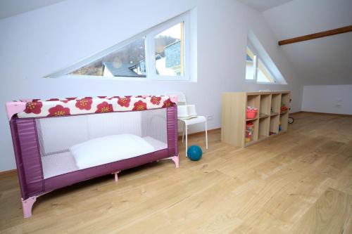 a childs bedroom with a purple bed and a window at Carpen View Residence in Săcele