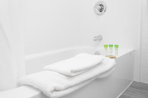 a white bathroom with white towels on a counter at Campus1 MTL Student Residence Downtown Montreal in Montreal