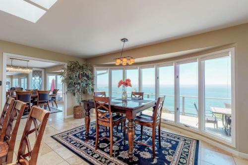 a dining room with a view of the ocean at Whalerock Luxury Home in Trinidad