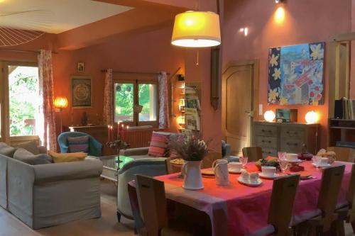 a living room with a table and chairs at Chambres d'hôtes à Pontonx in Buglose