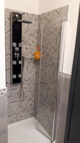 a shower with a glass door in a bathroom at Casa Leonardo Airport in Azzano San Paolo