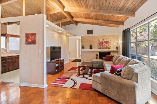 a living room with a couch and a table at Mid-century Home 2 miles to UF, Downtown, and Shands Plus Walk to Coffee Culture, Planet Fitness and Alfred A Ring Park in Gainesville