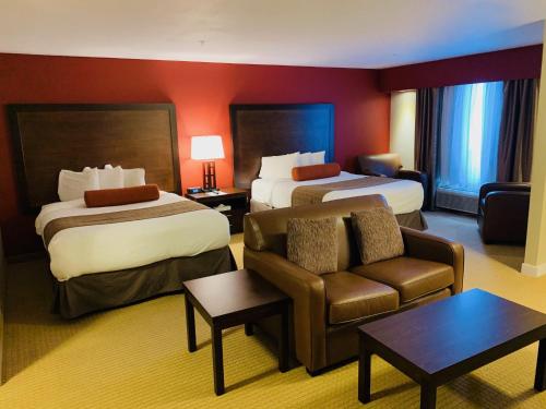 a hotel room with two beds and a couch at The Kanata Inns Invermere in Invermere