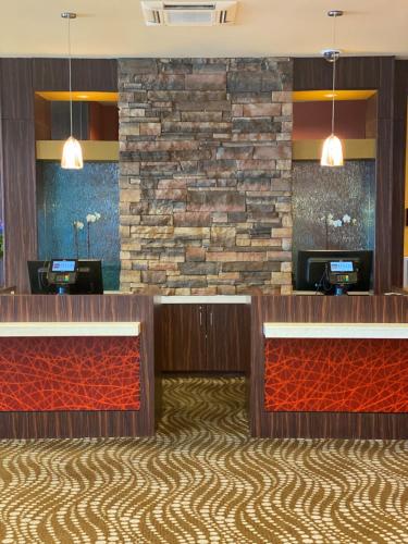 a lobby of a hotel with a stone wall at Apache Casino Hotel in Lawton