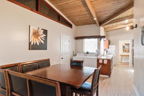 a dining room with a table and a kitchen at Mid-century Home 2 miles to UF, Downtown, and Shands Plus Walk to Coffee Culture, Planet Fitness and Alfred A Ring Park in Gainesville