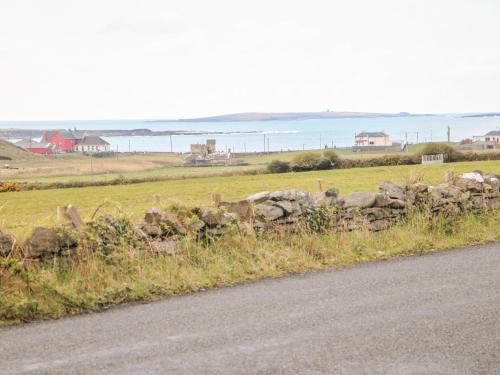 a stone wall on the side of a road at Cleary Cottage in Miltown Malbay