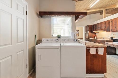 a kitchen with a white stove and a white refrigerator at Mid-century Home 2 miles to UF, Downtown, and Shands Plus Walk to Coffee Culture, Planet Fitness and Alfred A Ring Park in Gainesville