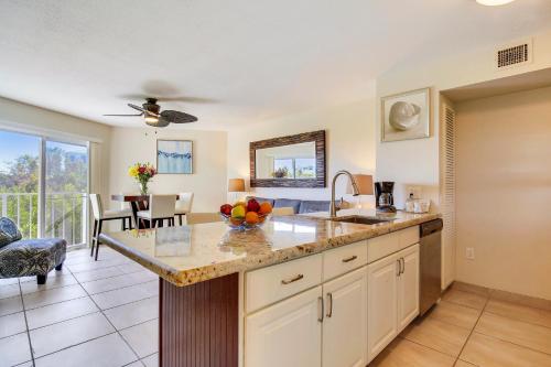a kitchen with a counter with a bowl of fruit on it at Ocean Pointe Suites at Key Largo in Key Largo