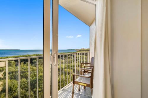 a balcony with a view of the ocean at Ocean Pointe Suites at Key Largo in Key Largo