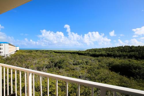 a view of the ocean from the balcony of a house at Ocean Pointe Suites at Key Largo in Key Largo