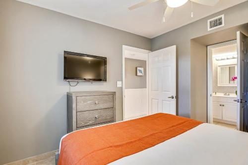 a bedroom with a bed and a flat screen tv at Ocean Pointe Suites at Key Largo in Key Largo