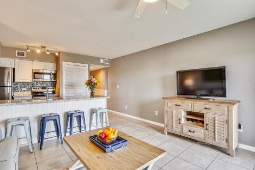 a kitchen and living room with a table and a tv at Ocean Pointe Suites at Key Largo in Key Largo
