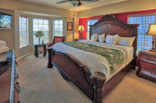 a bedroom with a large wooden bed and a desk at Ocean Pointe Suites at Key Largo in Key Largo