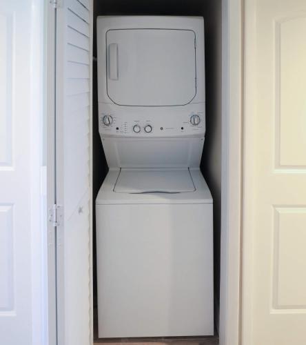 a washer and dryer sitting on top of a refrigerator at Ocean Pointe Suites at Key Largo in Key Largo