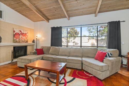 a living room with a couch and a coffee table at Mid-century Home 2 miles to UF, Downtown, and Shands Plus Walk to Coffee Culture, Planet Fitness and Alfred A Ring Park in Gainesville