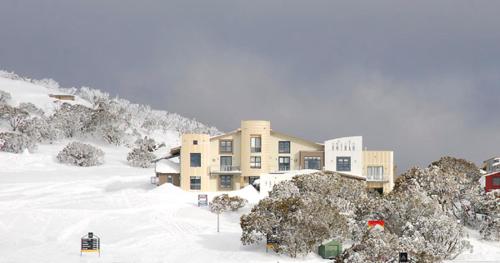 a building in the middle of a snow covered mountain at Chalet Hotham 7 in Mount Hotham