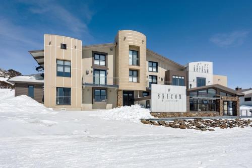 a large building with snow in front of it at Chalet Hotham 7 in Mount Hotham