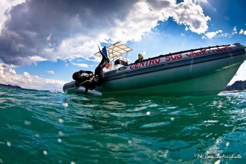 a boat in the water with a person on it at Hotel La Tripergola in Pozzuoli