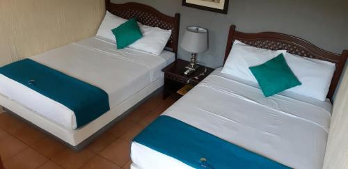 Ένα ή περισσότερα κρεβάτια σε δωμάτιο στο Hotel Real del Rio