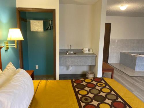 a bedroom with a bed and a bathroom with a sink at Americas Best Value Inn West Frankfort in West Frankfort